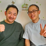 施術後に笑顔で並んで座る男性の利用者と施術スタッフ。落ち着いた院内でリラックスした雰囲気が伝わる写真